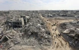 Cette vue aérienne montre des Palestiniens déplacés retournant au camp de réfugiés de Jabalia, dévasté par la guerre, dans le nord de la bande de Gaza, le 19 janvier 2025