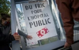 Des militants affichent un poster réclamant "du fric pour l'hÎpital public"le 15 juin 2020 à Nantes