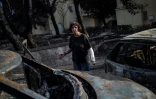 Une femme arpente une rue de Mati ravagée par les flammes, le 24 juillet 2018.