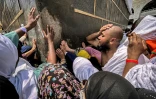 Des fidèles musulmans touchent le coin sud "yéménite" de la Kaaba, le sanctuaire le plus sacré de l'Islam, à la Grande Mosquée de La Mecque, ville sainte de l'Arabie saoudite, le 13 juin 2024