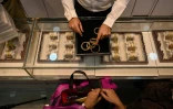 Un gérant de bijouterie montre des bracelets à une cliente, le 11 août 2021 à Bombay, en Inde  