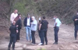 Image tirée d'une vidéo de l'AFPTV montrant l'ex-femme du tueur Michel Fourniret, Monique Olivier (c, en sweat gris) avec les enquêteurs lors d'une opération de recherche des restes d'Estelle Mouzin dans le bois d'Issancourt-et-Rumel, le 28 avril 2021