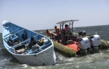 Des garde-côtes mauritaniens montent à bord d'une pirogue de pêche pour vérifier les documents et les permis de pêche lors d'une patrouille au large de Nouadhibou (Mauritanie), le 23 avril 2026