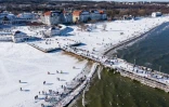 Une vue aérienne prise le 14 février 2021 montre des foules de touristes sur la plage gelée de Sopot, Pologne, après la levée de certaines restrictions