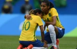 La star brésilienne Marta (g) consolée par Bruna après l'élimination par la Suède lors du tournoi de football, le 16 août 2016 à Rio