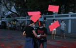 Photo provenant de Facebook et d'une source anonyme de manifestants déversant de la peinture rouge et distribuant des flyers à Rangoun, le 10 avril 2021 pour dénoncer le coup d'état militaire