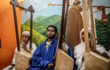 Ermias Haylay (c), enseignant et fondateur de l'école Eman Begena, joue de la begena avec des élèves à Addis-Abeba, le 13 février 2025