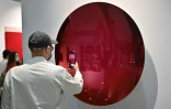 Un visiteur prend une photo de l'oeuvre intitulée "Brandy to Magenta, 2021" de l'artiste britannique Anish Kapoor, exposée à la foire Frieze à Séoul, le 2 septembre 2022