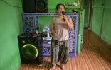 Une observatrice de la faune pour Borneo Future Indonesia,  Katarina Siti, en train de chanter avec une machine de karaoké qu’elle a achetée avec l’argent gagné en observant la faune dans le village de Sungai Ajung, à Kapuas Hulu, à Bornéo, le 2 septembre 2026