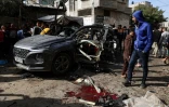 Des Palestiniens se rassemblent autour d'une épave de voiture après un bombardement israélien à Rafah, dans le sud de la bande de Gaza, le 8 janvier 2024