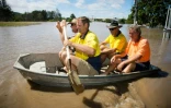 Un groupe de personnes dans une petite embarcation va inspecter une maison inondée de Beenleigh, le 31 mars 2017