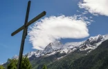 Une croix du Christ devant la montagne Bietschhorn à Ferden, le 29 mai 2025, au lendemain de l'effondrement du glacier du Birch qui a détruit la quasi totalité du village de Blatten, dans les Alpes suisses