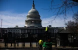 Des ouvriers installent des grilles de sécurité à l'extérieur du Capitole de Washington, le 2 mars 2025, en amont du discours le lendemain de Donald Trump