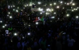 Des manifestants allument des bougies en hommage aux personnes tuées lors de la dispersion d'un sit-in, le 13 juillet 2019 à Khartoum