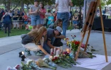 Des personnes déposent des fleurs en hommage à l'influenceur conservateur Charlie Kirk lors d'une veillée dans un mémorial improvisé à Orem, le 11 septembre 2025 dans l'Utah