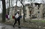 Une habitante passe devant des immeubles détruits par des frappes, le 4 avril 2023 à Avdiïvka, dans l'est de l'Ukraine