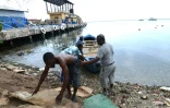 Des pêcheurs tirent un bateau pour le mettre à l'abri avant l'arrivée de l'ouragan Matthew à Kingston le 1er octobre 2016