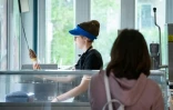 Sofia-Rose Adams, 13 ans, sert une glace à un client dans un café de Saint-Mathias-sur-Richelieu, Canada, le 12 juin 2022
