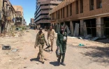 Des combattants loyaux à l'armée soudanaise patrouillent dans une rue de Khartoum, le 24 mars 2025