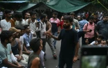 Abhijeet Dipke, fondateur du "parti des cafards", s'entretient avec des manifestants blessés lors d'une mobilisation réclamant la démission du ministre de l'Education, Dharmendra Pradhan, en raison de fraudes présumées aux examens universitaires, le 21 juillet 2026 à New Delhi
