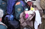 Photographie fournie le 1er janvier 2019 par le ministère russe des Situations d'urgence, montrant un bébé retrouvé vivant sous les décombres d'un immeuble touché par une explosion de gaz à Magnitogorsk, dans l'Oural, en Russie