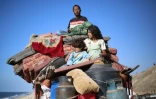 Des Palestiniens déplacés partent avec leurs biens vers le sud sur une route dans la zone du camp de réfugiés de Nousseirat, dans le centre de la bande de Gaza, après de nouveaux ordres d'évacuation israéliens pour la ville de Gaza le 16 septembre 2025