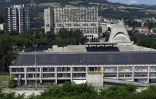 Vue, le 1er juillet 2016, de la Maison de la Culture (en bas) et de l'église Saint-Pierre (2e plan à droite) construites par Le Corbusier dans les années 50 à Firminy, prÚs de Saint-Etienne (Loire)