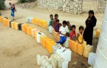 Des enfants déplacés de la ville yéménite de Hodeida attendant le 10 novembre 2018 de pouvoir remplir leurs bidons d'eau dans un camp installé à Abs, dans la province de
d'Al Hajjah (nord-ouest)