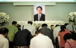 Des personnes se recueillent devant la photo de l'ancien Premier ministre japonais assassiné Shinzo Abe à Taipei, le 11 juillet 2022