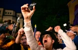 Des partisans du chef du parti AUR, George Simion ,saluent sa victoire au premier tour de la présidentielle, le 4 mai 2025 à Bucarest, en Roumanie