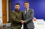 Le président ukrainien Volodymyr Zelensky (gauche) salue le président français Emmanuel Macron lors d'une réunion bilatérale, le 5 octobre 2023 à Grenade (Espagne)