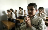 Des enfants chrétiens réfugiés d'Irak prient pendant le catéchisme dans une école catholique proche de Beyrouth le 15 novembre 2010 