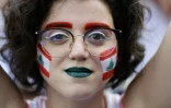 Drapeaux libanais peints sur les joues, une manifestante participe à un rassemblement contre le pouvoir à Zouk Mosbeh, au nord de Beyrouth, le 20 octobre 2019