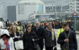 La population évacue l'aéroport de Bruxelles, le 22 mars 2016, après deux attentats