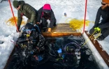 Un plongeur est extrait des eaux glacées lors d'un stage scientifique de plongée polaire, le 14 mars 2026 dans le lac de Kilpisjärvi, à l'extrême nord-ouest de la Finlande