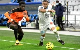 Le milieu de Marseille Dimitri Payet (d) déborde l'attaquant de Reims Boulaye Dia, le 19 décembre 2020 au Stade Vélodrome  