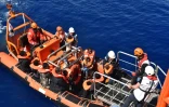 Des migrants s'apprêtent à monter à bord de  l'Aquarius, navire affrété par SOS Méditerranée et Médecins sans frontières (MSF) lors d'une opération de sauvetage le 24 mai 2016 en Méditerranée au large de la Libye