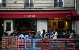Des personnes prennent un verre à la terrasse élargie d'un bar à Paris, le 23 juillet 2020