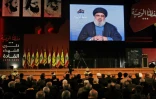 Le chef du Hezbollah libanais Hassan Nasrallah prononçant un discours par vidéoconférence lors d'une réunion du mouvement à Beyrouth le 16 février 2018