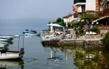 Des habitants prennent le soleil sur les rives du lac Ohrid, le 22 juin 2021 en Macédoine du Nord
