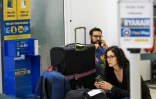 Des passagers de Ryanair attendent après l'annulation de leur vol en raison d'une grève des pilotes, le 10 aoüt 2018, à l'aéroport allemand de Schoenenfeld à Berlin