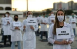 Des infirmières et des infirmiers brésiliens rendent hommage à des personnels soignants décédés du nouveau coronavirus, à Brasilia le 12 mai 2020