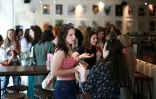 Des jeunes femmes se rencontrent dans un bar à Londres à la recherche de colocataires, dans le style d'un speed dating, le 11 mai 2024