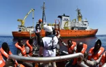Des migrants s'apprêtent à monter à bord de  l'Aquarius, navire affrété par SOS Méditerranée et Médecins sans frontières (MSF) lors d'une opération de sauvetage le 24 mai 2016 en Méditerranée au large de la Libye