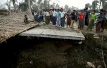 Des habitants sur un pont brisé par le cyclone Mocha, au camp de déplacés rohingyas de Khaung Dote Khar à Sittwe, le 15 mai 2023
