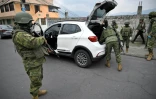 Des militaires fouillent un véhicule dans le quartier de Lucha de los Pobres, dans le sud de Quito, le 12 janvier 2024