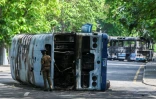Un policier inspecte un bus brûlé à la suite des manifestations antigouvernementales à Colombo, capitale du Sri Lanka, le 10 mai 2022