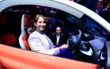 La ministre de l'Environnement Segolène Royal pose dans une voiture électrique Twizy 45 de chez Renault au Mondial de l'Automobile, le 1er octobre 2016 à Paris
