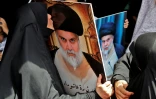 Des portraits du leader chiite Moqtada Sadr lors d'un rassemblement de ses partisans, le 26 août 2022 à Bagdad, en Irak 