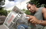 Un habitant de La Castellane, où a grandi Zinedine Zidane, découvre dans un quotidien l'annonce de la retraite internationale du meneur de jeu de l'équipe de France, le 12 août 2004 à Marseille